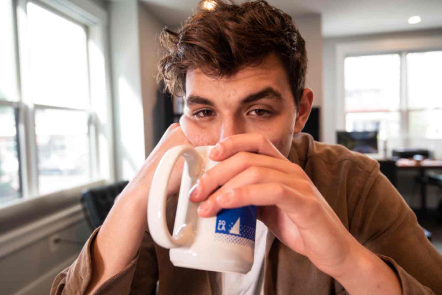 Fatigued and drinking coffee